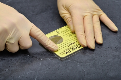 Ensure tension across the label and reattach it to the device